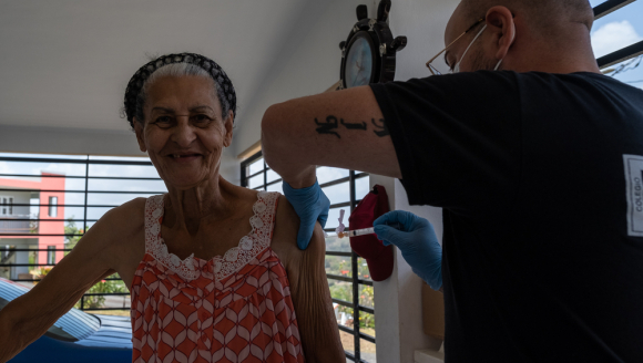 Mitarbeiter setzt einer Patientin in Puerto Rico eine Präventionsspritze gegen Covid-19. 