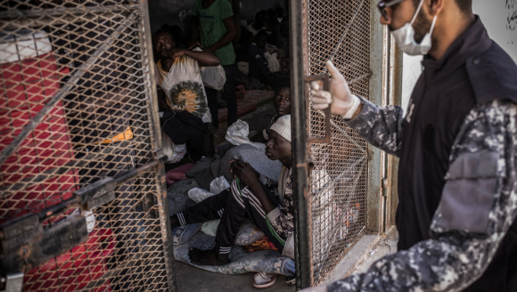 A guard is closing the door of a cell in Abu Salim detention center, in Tripoli, Libya.