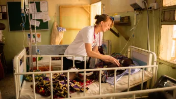 MSF Medical Doctor Valerie Weiss taking care of a young patient suffering from meningitis at Anka General Hospital, Nigeria.  A doctor is taking care of a child.