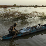 Ein Mann tritt in einem Kanu die Flucht vor der Flut an