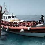 Aquarius is currently in the process of transferring 400 persons to two Italian Navy ships, at the request of the Italian MRCC. Aquarius was instructed by Maritime Rescue Coordination Centre in Rome to sail to Valencia to disembark the remaining 229 people.
 
While this appears to be a quick fix to the current political standoff, this should not set a precedent for future disembarkations. Rescued people should be disembarked in the nearest safe port available.